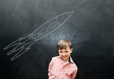 Buy stock photo Child, boy and portrait or happy by blackboard with drawing, missile and creative fun in classroom at school. Kid, student and smile for illustration, education or chalkboard with mockup at preschool