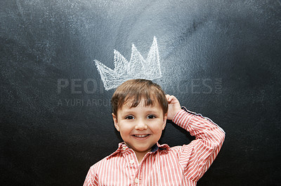 Buy stock photo Studio shot of an adorable little boy with chalk drawings behind him