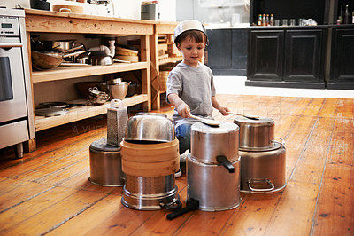 Buy stock photo Sound, boy and child on drums or pots on a floor, happy and playing fun music in house. Smile, creative or kid with pans for musical entertainment, silly or enjoying game in a kitchen on the weekend