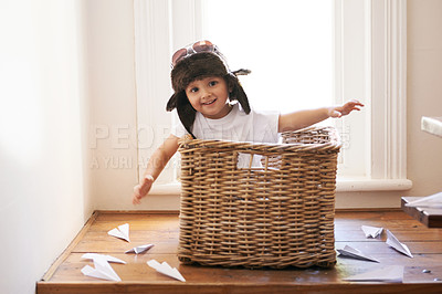 Buy stock photo Flying, fun and child with paper plane, fantasy, and imagination playing in basket in home. Adventure, little pilot and playful boy in box with future dream, growth and development with airplane.