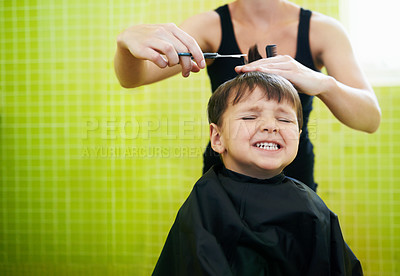 Buy stock photo Child, boy and hairdresser with haircut at salon for grooming, hairstyle and grimace with scissors. Barber, person and kid for hair treatment, haircare and hairdressing with comb or happy with mockup