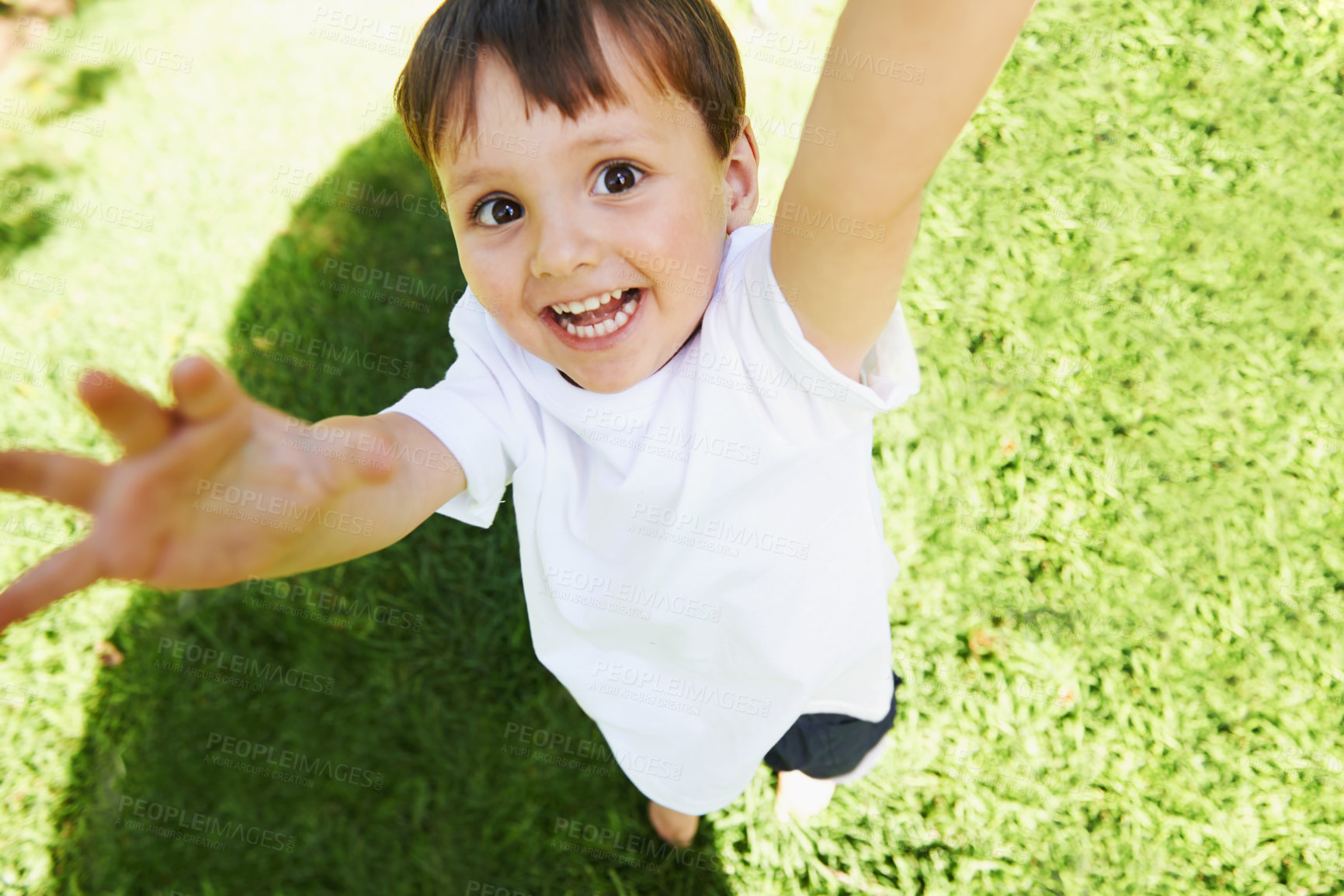 Buy stock photo High angle view of a little boy reaching up into the air