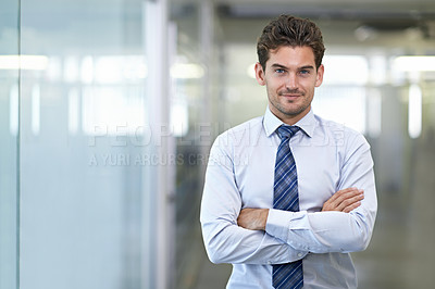 Buy stock photo Shot of a young businessman in a corporate office