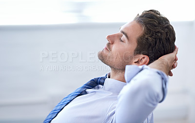 Buy stock photo A young businessman taking a break at the office