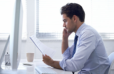 Buy stock photo Businessman, paper and computer in office for report, information and brainstorming with notes at desk. Professional man, document with reading and planning for budget, schedule or agenda at work