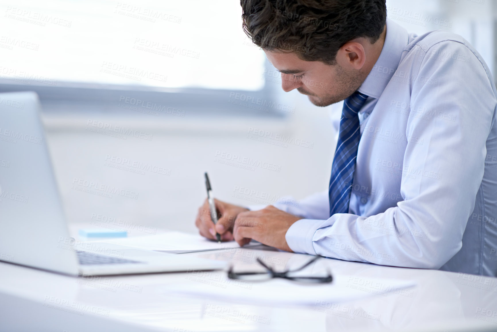 Buy stock photo Shot of a businessman working at his desk