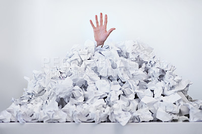 Buy stock photo Person, hand and paper pile or trapped in deadlines for work responsibilities for overwhelmed, exhausted or problem. Fingers, buried and employee reaching for help or business, burnout or documents