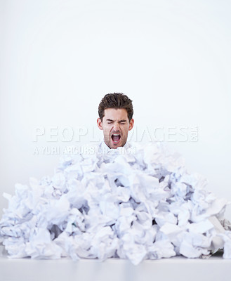 Buy stock photo Man, desk and frustrated with pile of paperwork, crisis and tired with burnout, stress and administration. Debt, bills and person lost in documents, overworked and overwhelmed with pressure in office