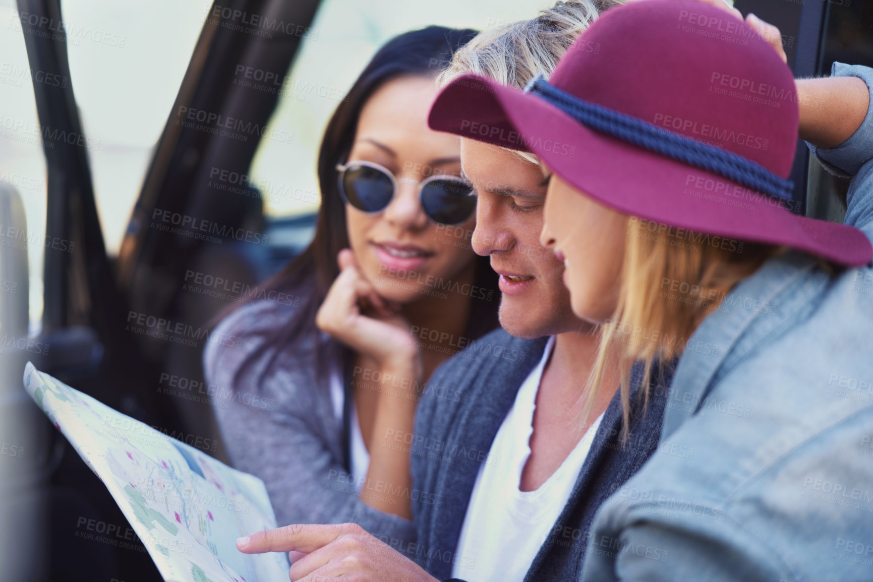 Buy stock photo Portrait of a group of friends leaning against their van, reading a map