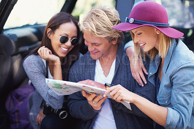 Buy stock photo Portrait of a group of friends leaning against their van, reading a map