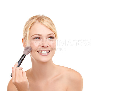 Buy stock photo A young woman applying make-up to her face isolated on white