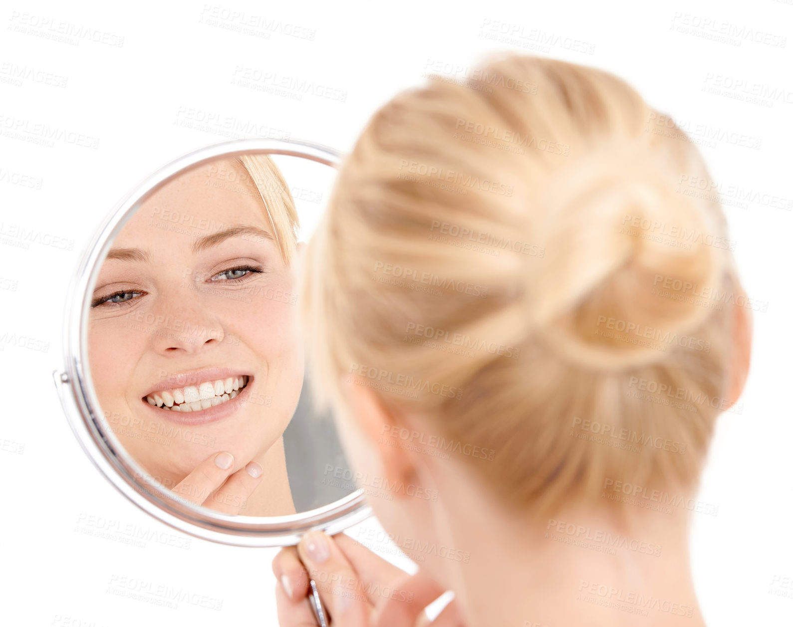 Buy stock photo Studio shot of a young woman admiring her skin in a mirror