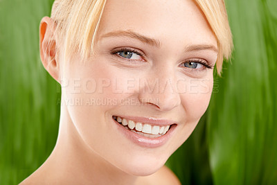 Buy stock photo Leaf background, natural beauty and woman for skincare, organic cosmetics with nature and glow in studio. Green, vegan treatment for skin and dermatology with smile for sustainability in portrait