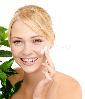 Buy stock photo Lotion on face, leaves and woman with beauty for dermatology organic cosmetics and smile on white background. Portrait, cream or sunscreen with green plant for eco friendly skincare and moisturizing