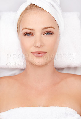 Buy stock photo High angle portrait of a young woman lying on a massage table at a spa