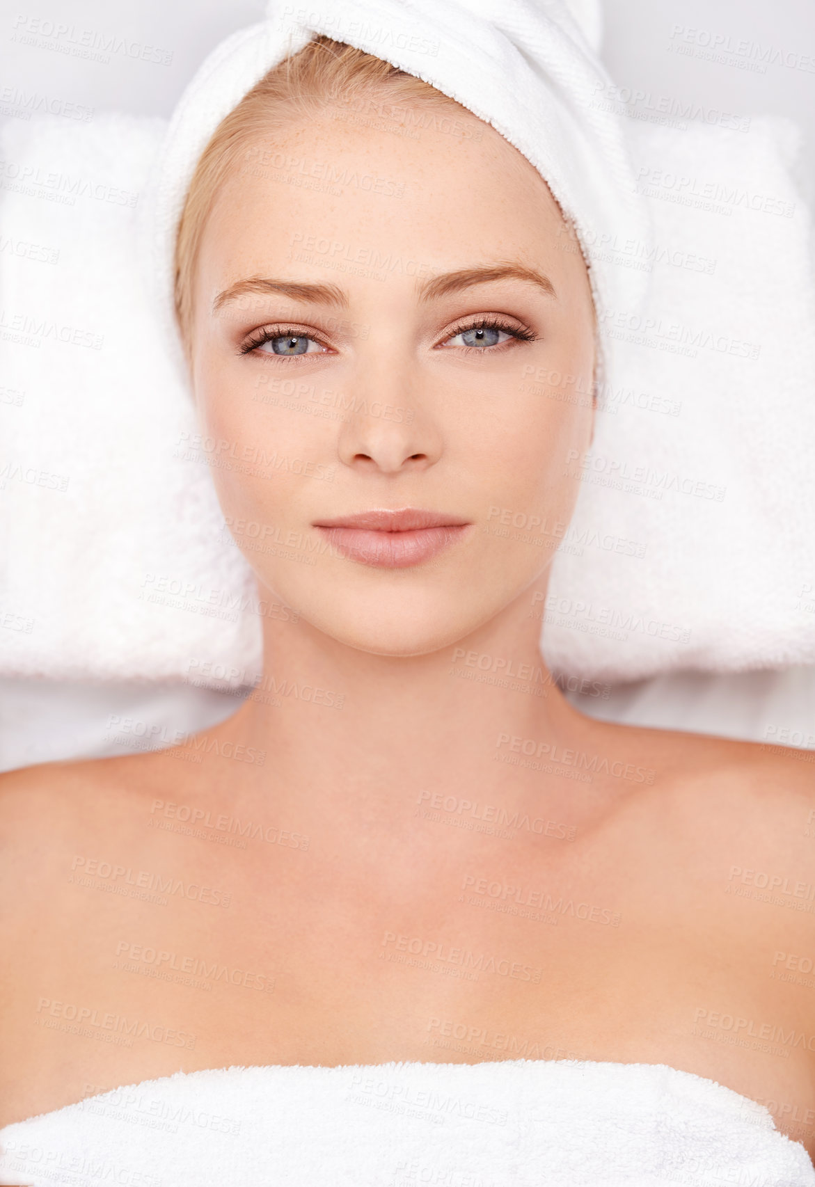 Buy stock photo High angle portrait of a young woman lying on a massage table at a spa