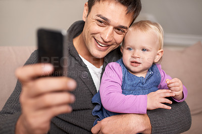 Buy stock photo Happy family, father and baby with selfie in home, love and care of new parent in living room. Dad, daughter and smile with cellphone for profile picture, cute and bonding together on sofa in house