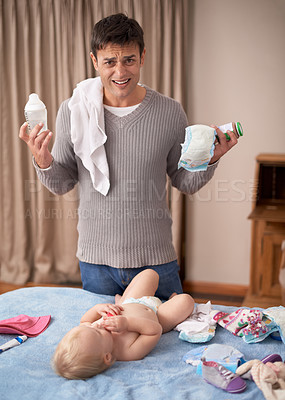 Buy stock photo A young father looking overwhelmed while standing by his baby daughter