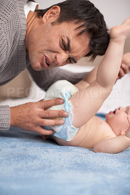 Buy stock photo Dirty diaper, smell and father cleaning baby on bed with gross expression or disgust at home, Family, love and dad face with kid in a bedroom for stink napkin, change and cold development routine
