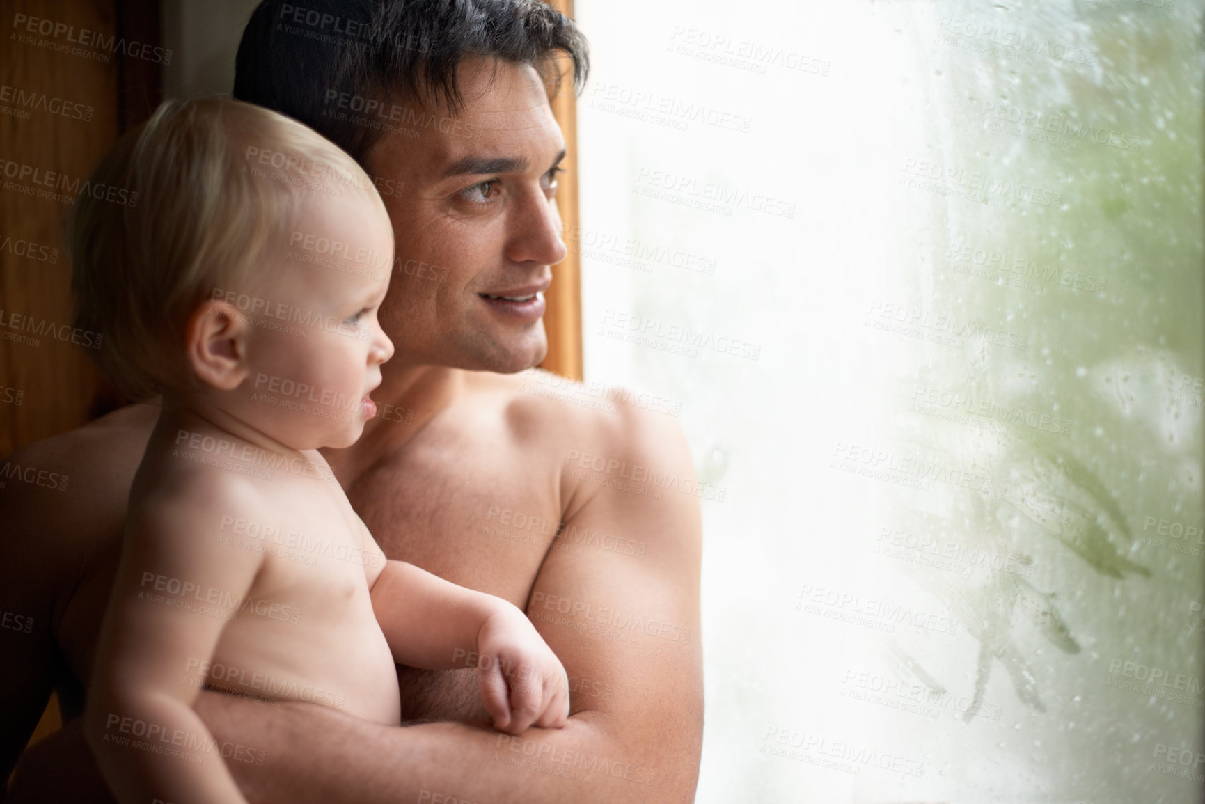 Buy stock photo Window, rain and father with baby in house for bonding, playing or having fun in their home together. Water, glass or dad with curious kid watching storm, weather or raindrops for learning or games

