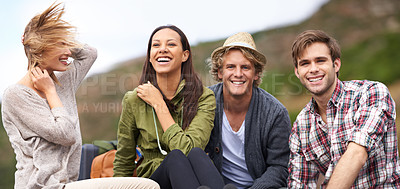 Buy stock photo Shot of a young group of friends enjoying themselves on a road trip
