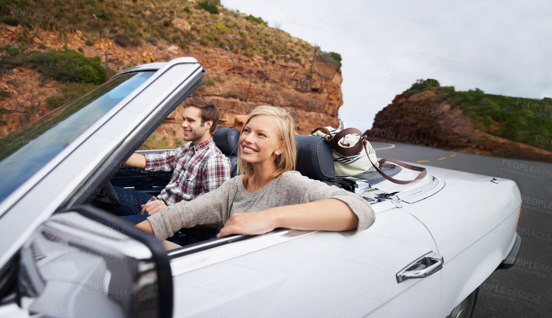 Buy stock photo Happy couple, car and driving on road trip for travel, holiday weekend or outdoor vacation on street in nature. Young man and woman with smile for transportation or getaway in convertible vehicle
