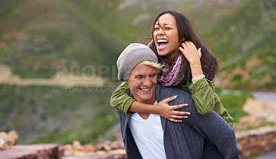 Buy stock photo Smile, couple and piggyback in nature, hiking and travel together on adventure for date on holiday. Funny, outdoor and man carrying woman, trekking and interracial people laughing in the countryside