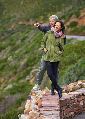 Buy stock photo Happy couple, hiking and nature in travel for sightseeing, journey or outdoor view together. Young man and woman with smile enjoying holiday, vacation or pointing in natural environment on mountain
