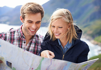 Buy stock photo Happy people, friends and pointing to map for travel, location or destination on mountain in nature. Young couple with smile, document or paper with routes for navigation, help or outdoor tourism