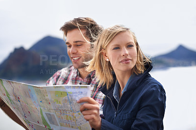 Buy stock photo Happy couple, map and thinking in nature for travel, location or next destination outside. Young man and woman in wonder or thought with document or paper for direction, route or path on outdoor trip