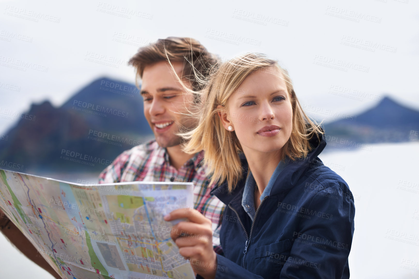 Buy stock photo Happy couple, map and thinking in nature for travel, location or next destination outside. Young man and woman in wonder or thought with document or paper for direction, route or path on outdoor trip