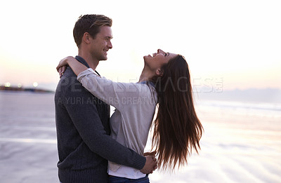 Buy stock photo Love, hug and couple on beach at sunset for tropical holiday adventure, relax and bonding together. Commitment, happy man and woman on romantic date with ocean, evening sky and embrace on vacation.