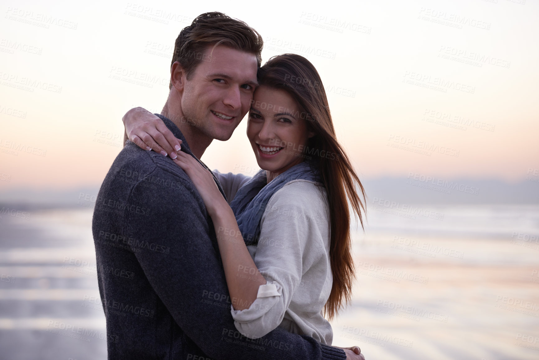 Buy stock photo Love, hug and portrait of happy couple on beach at sunset for tropical holiday adventure, relax and bonding together. Evening, man and woman on romantic date with ocean, sky and embrace on vacation.