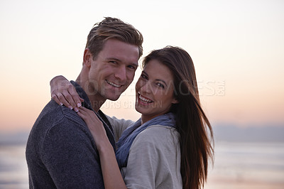 Buy stock photo Sunset, hug and portrait of happy couple on beach for tropical holiday adventure, love and bonding together. Evening, happy man and woman on romantic date with ocean, sky and embrace on vacation.