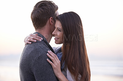 Buy stock photo Couple, hug and smile at beach on vacation, love or care with romance in nature, outdoor or ocean. Man, woman and embrace on date, bonding or happy in sunset for memory on holiday by sea in Australia