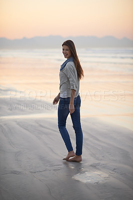Buy stock photo Woman, walking and happy in portrait at beach, sunset and vacation with nature to relax by ocean. Girl, person and outdoor by sea with feet in sand for holiday, adventure or smile by sea in Australia