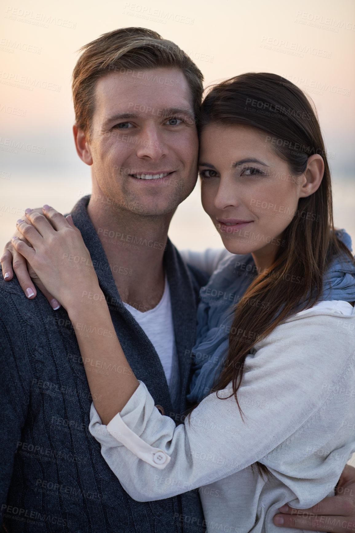 Buy stock photo Love, hug and couple on beach with sunset sky for tropical holiday adventure, relax and bonding together. Commitment, happy man and woman on romantic date with ocean, evening and embrace on vacation.