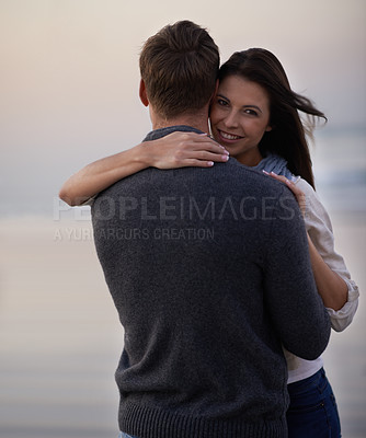 Buy stock photo Love, smile and portrait of couple at ocean for tropical holiday adventure, hug and bonding together. Relax, happy man and woman on romantic sunset date with beach, evening and embrace on vacation
