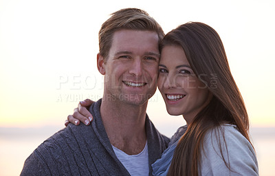 Buy stock photo Love, hug and portrait of couple at ocean at sunset for tropical holiday adventure, relax and bonding together. Evening, happy man and woman on romantic date with beach, sky and embrace on vacation.