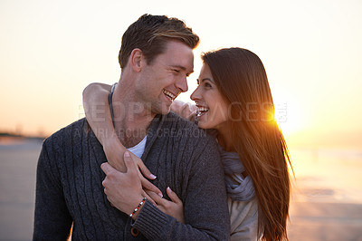 Buy stock photo Romance, embrace and happy couple on beach at sunset for tropical holiday adventure, love and bonding together. Smile, man and woman on date with ocean, evening sky and hug on vacation in nature.