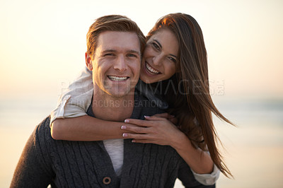Buy stock photo A young couple enjoying a romantic moment together at the beach