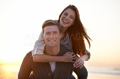 Buy stock photo Portrait, piggy back and couple on beach at sunset for tropical holiday adventure, relax and bonding together. Love, happy man and woman on romantic date with ocean, evening sky and vacation