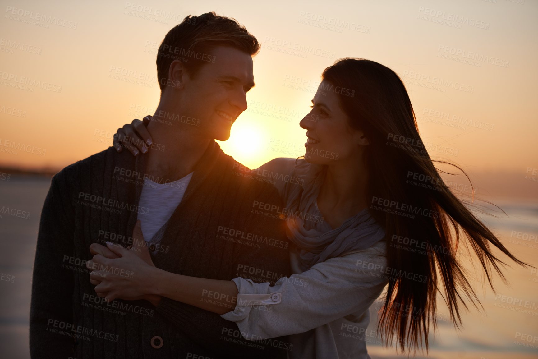 Buy stock photo Couple hug, sunset on beach and travel for bonding, romance outdoor with love and trust. Happiness, support and loyalty with people in relationship, sunshine and adventure together with smile