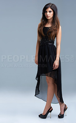 Buy stock photo Shot of a beautiful young woman modeling elegant fashion in studio