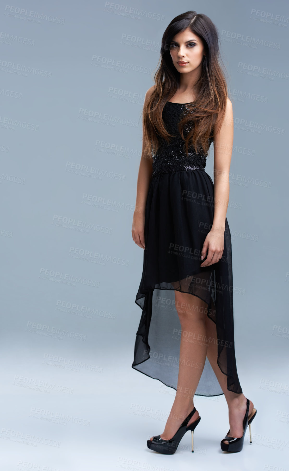 Buy stock photo Shot of a beautiful young woman modeling elegant fashion in studio