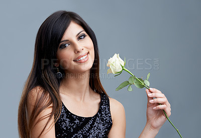 Buy stock photo Fashion, flower and portrait of woman on gray background for beauty, cosmetics and confidence. Happy, smile and face of person with rose, floral and bloom for spring, romance and present in studio