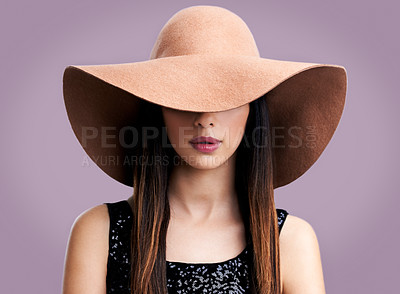 Buy stock photo Shot of a beautiful young woman modeling fashion-wear in studio