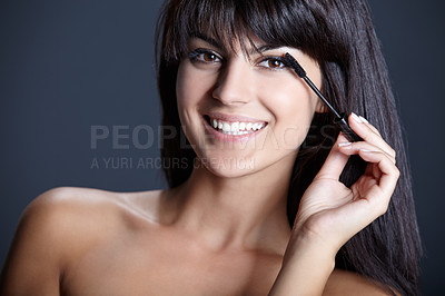 Buy stock photo Beauty, makeup and portrait of woman with mascara for skincare, spa facial and application. Lashes, smile and cosmetics with face of girl on dark blue background with brush, tools and happiness.