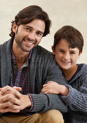 Buy stock photo Portrait of a young father and son sitting on the sofa