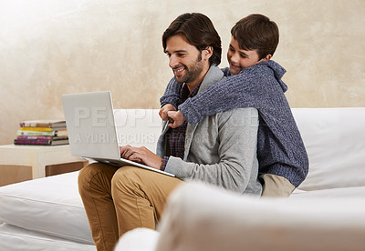 Buy stock photo A young boy and his father playing on a laptop